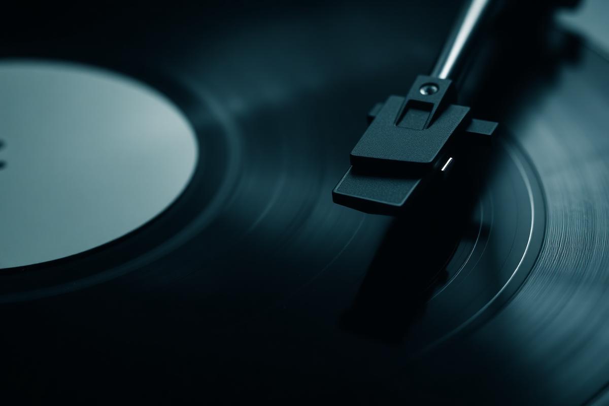 Record player needle on black vinyl